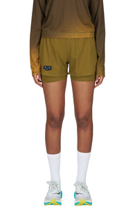 Women's running shorts in Gold Olive, featuring an inner lining and side vents. The 3-inch Flow Shorts offer a soft stretch and are made from ECONYL®. Podium Logo on the front and a reflective "Finish in a Good Place" slogan on the back. Includes one pocket in the inner lining and a hidden pocket at the back. Also available in a 5-inch length.