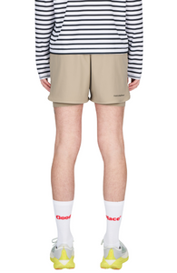 Running shorts in Warm Sand, featuring an inner lining and side vents. The 3-inch Flow Shorts offer a soft stretch and are made from ECONYL®. Podium Logo on the front and a reflective "Finish in a Good Place" slogan on the back. Includes one pocket in the inner lining and a hidden pocket at the back. Also available in a 5-inch length.