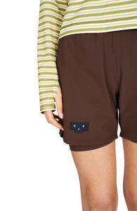 Women's running shorts in Red Brown, featuring an inner lining and side vents. The 5-inch Flow Shorts offer a soft stretch and are made from ECONYL®. Podium Logo on the front and a reflective "Finish in a Good Place" slogan on the back. Includes one pocket in the inner lining and a hidden pocket at the back. Also available in a 3-inch length.