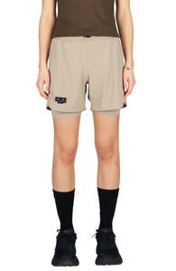 Women's running shorts in Warm Sand, featuring an inner lining and side vents. The 5-inch Flow Shorts offer a soft stretch and are made from ECONYL®. Podium Logo on the front and a reflective "Finish in a Good Place" slogan on the back. Includes one pocket in the inner lining and a hidden pocket at the back. Also available in a 3-inch length.