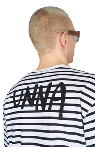 Men’s striped long sleeve Running T-Shirt in White and Navy, featuring raglan sleeves with thumbholes. It has a water-based sublimation-printed stripe pattern and is made from quick-drying, post-consumer recycled polyester with 4-way stretch for flexibility, ventilation, and breathability. A bold, hand-drawn UNNA text on the back.